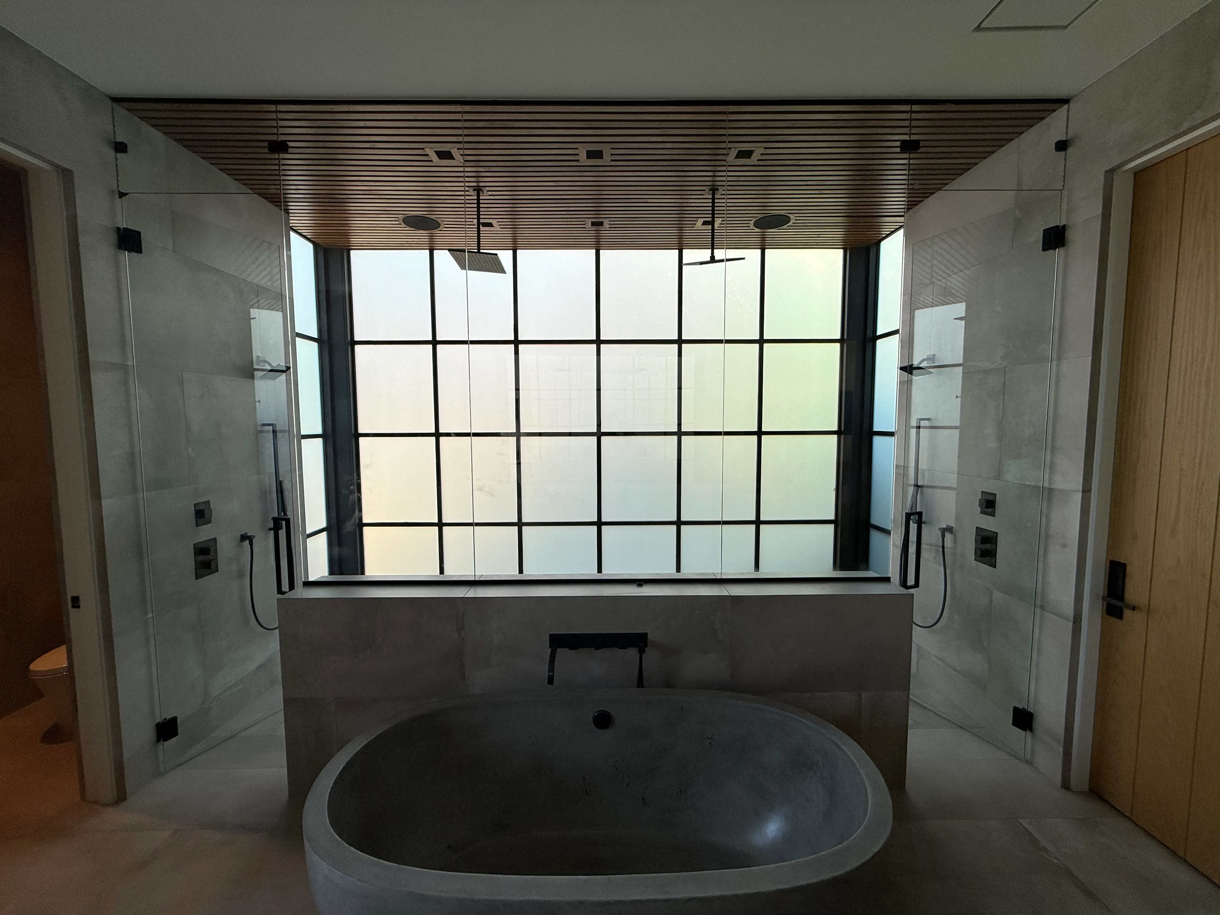 Luxury bathroom with a Revive smart glass window, frosted