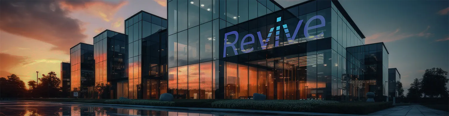 Glass facade transformed into a branded projection surface displaying the Revive logo